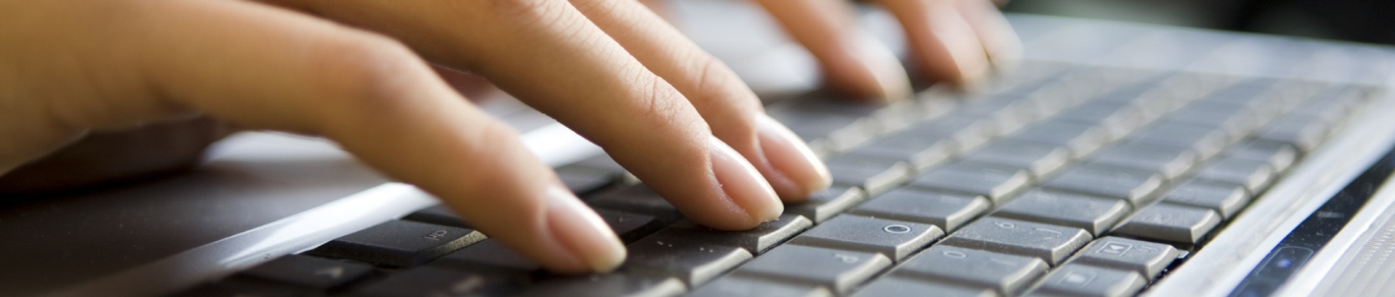 Person learning and typing on a laptop computer.