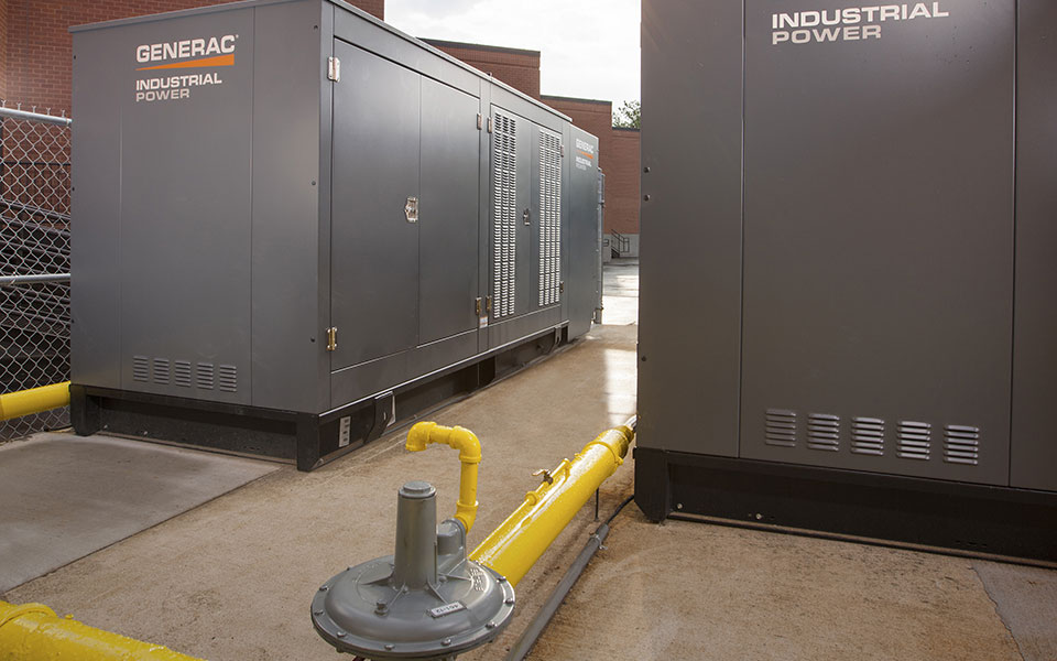 Two Generac Industrial Power generators outside of building.