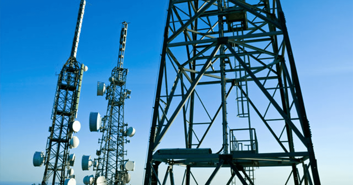 Communications tower outside with blue skies.