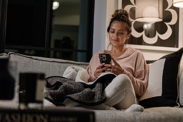 image of a woman on her phone on the couch